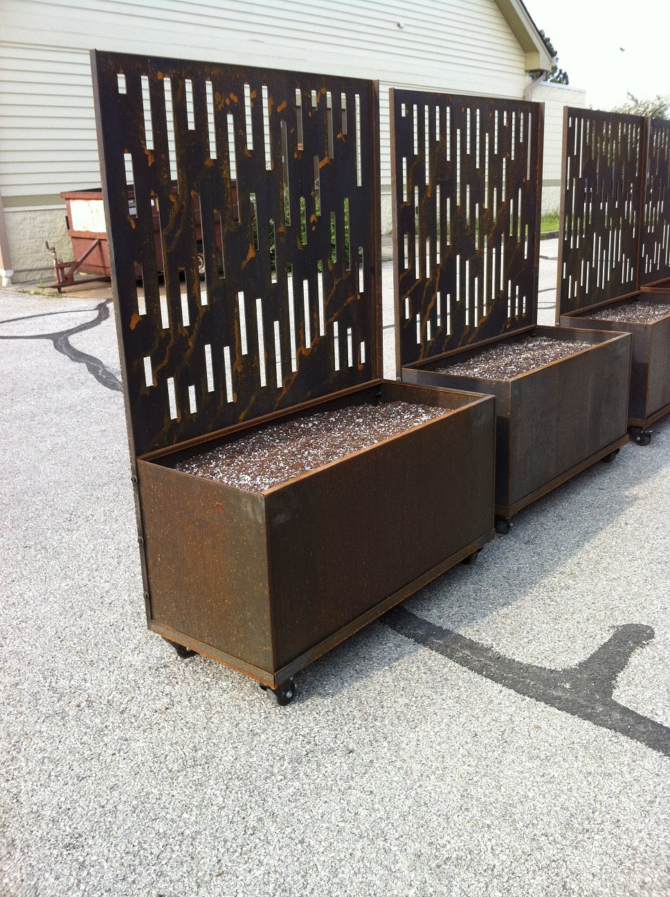 Planters with decorative laser cut corten steel privacy screens